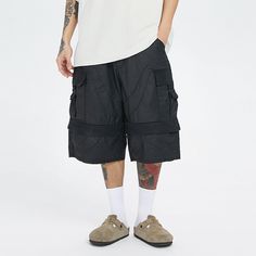 The Spliced Big Pocket Waxed Shorts perfectly blend avant-garde style with meticulous craftsmanship. These slightly oversized shorts feature a deconstructed patchwork design, giving them a unique and edgy look. The adjustable waistband ensures a customized fit, while the two large front pockets with secure flap closures provide ample storage and enhanced security. Made from premium 100% cotton fabric, these shorts offer both comfort and durability, making them an essential addition to your stree Urban Patchwork Bottoms For Spring, Techwear Shorts With Belt Loops For Streetwear, Urban Streetwear Shorts With Belt Loops, Urban Shorts With Belt Loops For Streetwear, Summer Streetwear Patchwork Bottoms, Summer Streetwear Bottoms With Patchwork, Spring Streetwear Cargo Shorts With Multiple Pockets, Cargo Shorts With Multiple Pockets For Spring Streetwear, Spring Streetwear Shorts With Patch Pockets