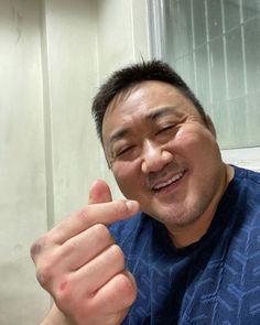 a man giving the thumbs up sign in front of him