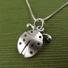 "This pretty little ladybug is made of sterling silver. The pendant is TINY, measuring about 1/2\" (1.2 cm) in length.  Super cute! You can purchase just the pendant/charm, or complete the necklace with a sterling silver chain.  For the matching ladybug earrings:  www.etsy.com/listing/228278367/tiny-ladybug-earrings © Stick Man Creations This is our own original design, handcrafted by us, and signed on the back with our logo.   If you want to read more about the process, click here:  www.etsy.co Cute Nickel-free Pendant Jewelry, Cute Nickel-free Sterling Silver Necklaces, Cute Silver Pendant Charm Necklace, Cute Silver Charm Necklaces With Lobster Clasp, Cute Silver Charm Necklaces, Cute Sterling Silver Pendant Charm Necklaces, Cute Sterling Silver Pendant Charm Necklace, Cute Sterling Silver Necklace For Everyday, Cute Round Silver Necklace