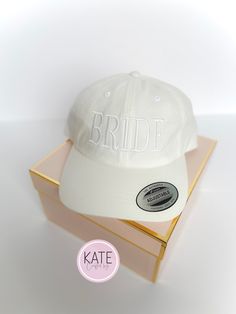 Embroidered BRIDE Dad Cap (white/white) No returns or exchanges accepted White Hat With Embroidered Logo And Curved Visor, White Dad Hat, One Size Fits Most, White Baseball Cap With Embroidered Logo, Adjustable Fit, Adjustable White Baseball Cap With Embroidered Logo, White Embroidered Logo Hat One Size, White Adjustable Baseball Cap With Embroidered Logo, Adjustable White Dad Hat, White Embroidered Hat One Size, White Adjustable Dad Hat With Curved Brim