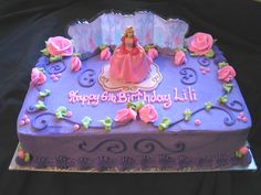 a purple birthday cake with a princess figure on it