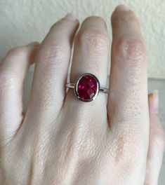 "A Classic oval shaped Faceted Lab Created Ruby Sterling Silver Ring featuring a comfort fit band with a bezel around the stone. This makes a great birthstone ring for those July Birthdays! Wrapped in a box ready for gift giving.(r-537) RING INFO ---------------- STERLING SILVER Stone with Bezel measure 11.5mm x 10mm July BIRTHSTONE *Follow us @belesasjewelry on Instagram for promotions/giveaways *LIKE* us on Facebook http://www.facebook.com/Belesas *If you like the ring, please click on the \"P Modern Ruby Ring With Bezel Setting, Adjustable Ruby Ring With Bezel Setting, Modern Ruby Rings With Bezel Setting, Adjustable Red Oval Ruby Ring, Adjustable Oval Red Ruby Ring, Red Round Ring For Everyday, Everyday Red Round Ring, Modern Red Open Ring, Classic Adjustable Red Ring