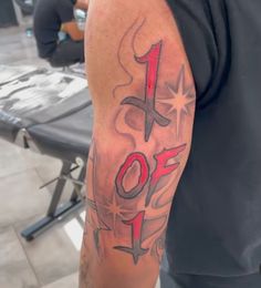 a man with a tattoo on his arm that says 1 off in red and black ink