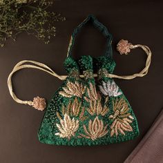 "Classic Emerald Green Wedding Evening Purse | Art Deco Lotus Embroidered Zardozi Handbag Pouch Purse | Bridesmaids Velvet Drawstring Purse Size: 10\" x 10\"(inches) Designed with the heart, this beautiful bag are eye catchy and made of premium material. Key Features: Embroidery art work. (zardosi work). This potli is good match with both Indian and western outfits and are superb for wedding and festive parties. This would be best complement to your designer saree, lenhga or any other kind of dress. This is the combination of traditional and modern embroidery work. This is enough to keep your accessories and all needed essentials and it can be a best gift for any woman." Elegant Green Bag With Floral Embroidery, Elegant Green Bags With Floral Embroidery, Elegant Green Potli Bag For Festivals, Green Potli Bag For Wedding, Green Bag With Zari Work For Wedding, Elegant Green Potli Bag With Handwork, Elegant Embroidered Green Bags, Wedding Pouch Bag With Floral Embroidery, Elegant Green Embroidered Bag