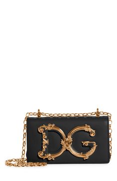 A D&G logo with baroque-inspired gilt flourishes ornately brands this compact leather bag designed with a sliding chain strap that can be worn doubled or long. Style Name:Dolce&gabbana Girls Logo Leather Phone Crossbody Bag. Style Number: 6164781. Rectangular Gold Shoulder Bag With Logo Plaque, Elegant Rectangular Shoulder Bag With Logo Plaque, Gold Crossbody Shoulder Bag With Logo Plaque, Gold Crossbody Shoulder Bag With Logo, Evening Clutch Bag With Logo Plaque, Evening Clutch Bags With Logo Plaque, Evening Clutch With Logo Plaque, Luxury Clutch Bag With Logo Plaque, Classic Gold Bags With Logo Plaque