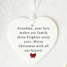 a ceramic heart ornament that reads grandma, your love makes our family shine brighter every year merry christmas with all our hearts