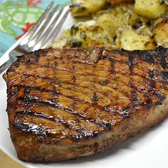 a steak and potatoes on a plate with a fork