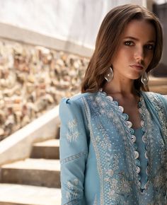 Brand: Republic WomenswearProduct Code: D4-B AzureCollection: ILANA by Republic Eid Luxury Lawn Unstitched CollectionFabric: Lawn DESCRIPTION: Azure invites you to gaze upon a sky-like horizon, a blue canvas scattered with white florals, enriched with tilla work, and accented with hints of pink and green, shaping the floral patterns into captivating boxes. DESIGN DETAILS: Front Center Embroidered (Lawn) 1-PC Front Left Embroidered (Lawn) 1-PC Front Right Embroidered (Lawn) 1-PC Front Patches Left Embroidered (Organza) 3-PC Front Patches Right Embroidered (Organza) 3-PC Neckline Embroidered (Organza) 1-PC Back (Lawn) 1-MTR Sleeves Embroidered (Lawn) 44"" Sleeves Border Embroidered (Organza) 1.10-MTR Sleeves Patti Embroidered-1 (Organza) 1.10-MTR Sleeves Patti Embroidered-2(Organza) 1.10-MTR Republic Womenswear, Boxes Design, Lawn Dresses, Luxury Pret, Formal Wear Women, Suit Collection, Pakistani Designer Suits, Pakistani Lawn Suits, Kurta Design