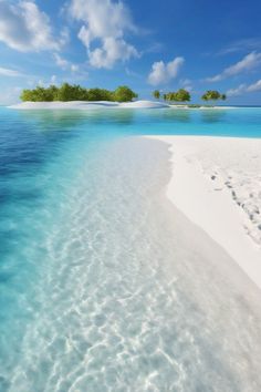 an island in the middle of water with sand and trees on it's sides