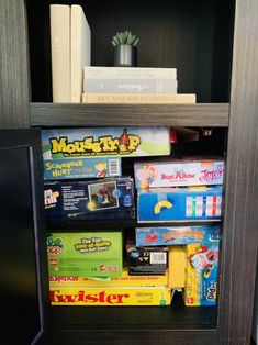 a book shelf filled with games and books