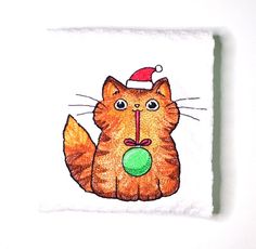 an orange cat with a santa hat on it's head is holding a green ball