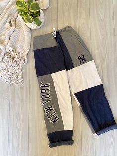 MLB Patchwork Sweatpants - New York Yankees Style: patchwork sweatpants - unisex  Graphic:  MLB - New York Yankees Colors: Navy, white, and gray Details: Large pocket, Elastic waistband and string - adjustable fitting SIZE: Adjustable XS up to LARGE Measurements are all taken laying flat. Waistband can tie down to 14" and comfortably fit up to 42" Waistband (adjustable) 14" - 42" Rise 38.5" Inseam" 29" This is a sustainable, 1 of 1 product that was upcycled & handcrafted by 2nd hand material. Madsew'n ♻️ Instagram & TikTok: Madsew.n Fb page: Madsew'n Patchwork Sweatpants, Yankees Outfit, New York Yankees, Mlb, Sweatpants, Gender Neutral, New York, Adult Outfits, Pants