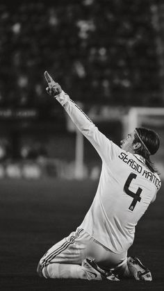 a man kneeling down on top of a soccer field