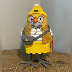 a yellow bird with glasses and a hat on it's head holding a guitar