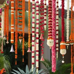 an assortment of flowers and decorations hanging from the ceiling