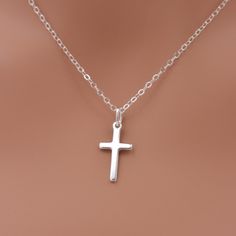 This beautiful piece is made of solid sterling silver for a lasting keepsake. Features a cross in a small 3/4 inch size, set on a sterling silver chain that closes with an easy-to-use spring ring clasp. Comes in a little gift box.  SEND AS A GIFT: You can send this gift directly to the recipient, along with your personalized note. Just select "this is a gift" and leave your note. Be sure to update the address (to your recipient's) when ordering.  SIZING - PLEASE READ: Please note that necklaces will fit differently depending on a person's size. I recommend measuring to be safe. Please note that my jewelry is not intended for anyone 12 years of age or younger. Note that small pieces of jewelry (or if the jewelry becomes broken) is a choking hazard for children and should not be used around Sterling Silver Cross Charms For Anniversary, Sterling Silver Cross For Anniversary, Sterling Silver Cross Pendant Necklace For Anniversary, Sterling Silver Cross Jewelry For Anniversary, Sterling Silver Cross Necklace, Hallmarked, Sterling Silver Cross Necklace Hallmarked, Classic Sterling Silver Cross Charm, Stamped 925 Cross Necklace For Gift, Silver Stamped 925 Cross Necklace For Gift