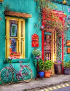 a bike is parked in front of a colorful building