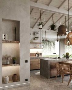 an open kitchen and dining room with plants hanging from the rafters over the counter