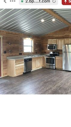 an empty kitchen with wooden cabinets and stainless steel appliances