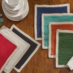 four crocheted placemats on a wooden table