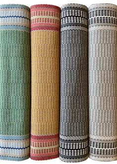 four rolls of woven fabric in different colors