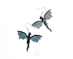 "✨ Dragon earrings measuring 4 x 5 cm (1 1/2\" x 2\") - the whole drop length is 6 cm (2 3/8\") ✨ These whimsigoth earrings are crafted from wood with sterling silver earwires ✨ The dragons are processed within 1-3 business days 🌟🐉Step into the enchanting world of fantasy with our whimsigoth dragon earrings - a captivating blend of gothic elegance and whimsical charm!  These dangle earrings are true representative of the dark academia aesthetic, and the charm of gothic style. Crafted to capture the essence of fantasy worlds, these earrings feature intricately designed dragons, hand-painted with tons of details in black and blue-gray shades and adorned with liquid glass for extra shine. Measuring the perfect length for dangle earrings, these wooden creations are suspended from sterling si Gothic Elegance, Earrings Gothic, Dragon Earrings, Gothic Halloween, Small Jewelry Box, Dark Academia Aesthetic, Academia Aesthetic, Halloween Jewelry, Unique Christmas Gifts