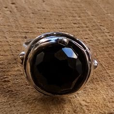 Notorious Wind This sterling silver ring is made with a circular structure. At the center of the bezel sits a rose-cut black onyx gemstone. R1470-11 © 2011-2015 Artisanimpact Inc. All rights reserved. Construction & Dimensions: Materials: sterling silver, onyx Approximate diameter: 20mm (0.8in) We can make any size, including quarter sizes. Please choose your size in the drop down menu, when you check out. About our jewelry Artisanimpact features a variety of brass, silver and 14k gold jewel Black Oxidized Finish Rings Gift, Unique Black Oxidized Finish Ring, Unique Black Ring With Oxidized Finish, Gift Black Ring With Oxidized Finish, Black Oxidized Ring Jewelry, Black Oxidized Finish Ring, Classic Black Rings With Oxidized Finish, Circular Structure, Black Gemstone Ring