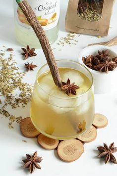 aniset in a glass with cinnamon and star anisets around it