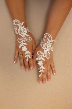 two hands with white lace on them