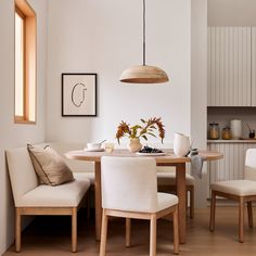 a dining room table with chairs and a bench