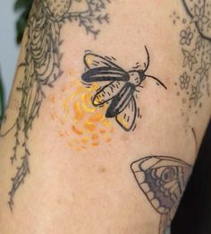 a close up of a person's arm with tattoos on it and a butterfly