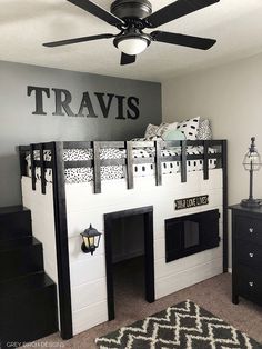 a bedroom with bunk beds and black dressers