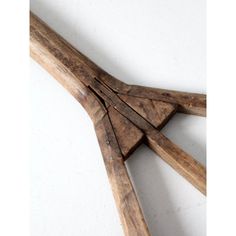 several pieces of wood are arranged in the shape of an arrow on a white surface