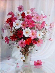 a vase filled with lots of pink and white flowers