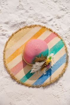 Bask in the sun with our Tropical Sunshine Sun Hat! The playful rainbow stripes add a pop of color while the cream and gold band adds a touch of elegance. Featuring white and gold feathers, bright flowers, and a gold sequin sun patch, this hat is perfect for adding some fun to your summer outfit. This hat is ONE OF A KIND, created by our owner Stephanie. To receive item quicker, expedited shipping is available at checkout. Gold Feathers, Bright Flowers, The Cream, Gold Sequin, Cream And Gold, Rainbow Stripes, Sun Hat, Gold Band, Summer Outfit