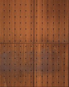 a wooden wall with holes in it and a clock on the top of each panel