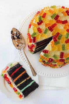 a piece of cake with gummy bears on it and a fork next to it