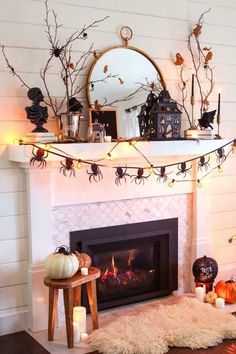 a fireplace decorated with halloween decorations and candles