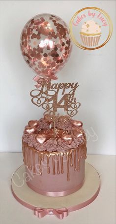 a birthday cake with pink icing and a balloon on top that says happy 44th