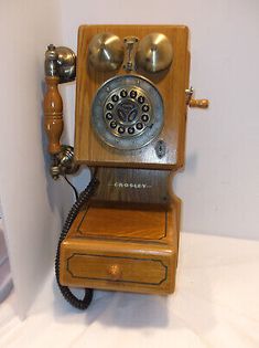 an old fashioned wooden phone is on display