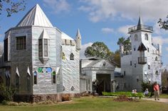 two people are standing in front of a castle like building that looks like it is made out of paper