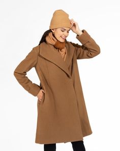 Discover the epitome of American-made elegance with this classic camel colored wool coat. This timeless knee-length coat is not only stylish but also provides exceptional warmth. Crafted with meticulous attention to detail, it features a fully lined body and sleeves, in a contrasting stripe lining.Designed for both style and functionality, this camel coat boasts a deep collar, deep on-seam side pockets, and adjustable cuffs, ensuring a perfect fit for arms of all lengths. For a secure closure, w Fitted Wool Sweater Coat In Brown, Beige Wool Shawl Collar Outerwear, Elegant Brown Outerwear With Shawl Collar, Camel Outerwear With Lapel Collar For Winter, Camel Lapel Collar Outerwear For Winter, Camel Long Wool Coat For Workwear, Long Camel Wool Coat For Work, Brown Wool Pea Coat For Cold Weather, Brown Notch Lapel Wool Coat For Winter