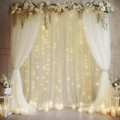 an image of a wedding stage setting with candles and flowers on the curtained wall