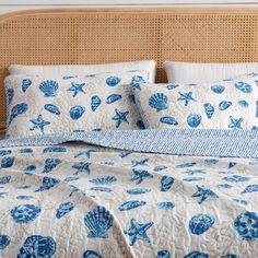 a bed with blue and white shells on it