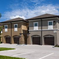 two story houses with garages in front of them