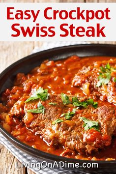 easy crockpot swiss steak recipe in a cast iron skillet on a wooden table