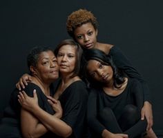 three women are hugging each other and posing for the camera