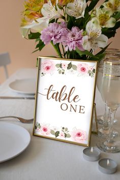 a table with flowers and place cards on it