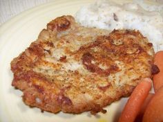 some food is on a white plate with carrots and mashed cauliflower