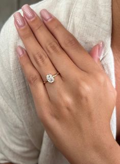 a woman's hand with a diamond ring on it